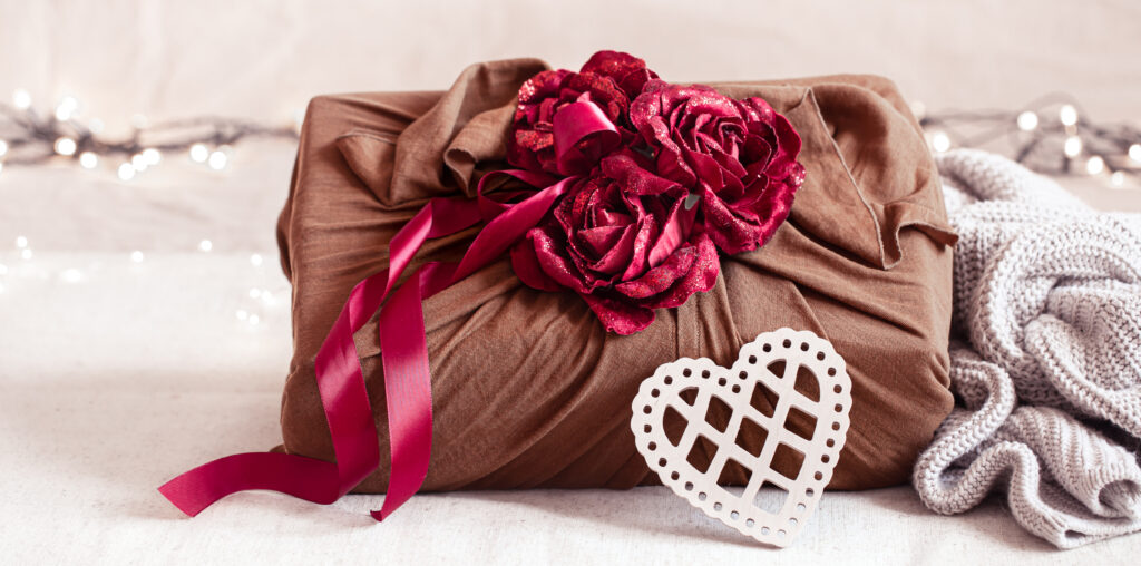 valentine's day gift decorated with roses and ribbons close up.